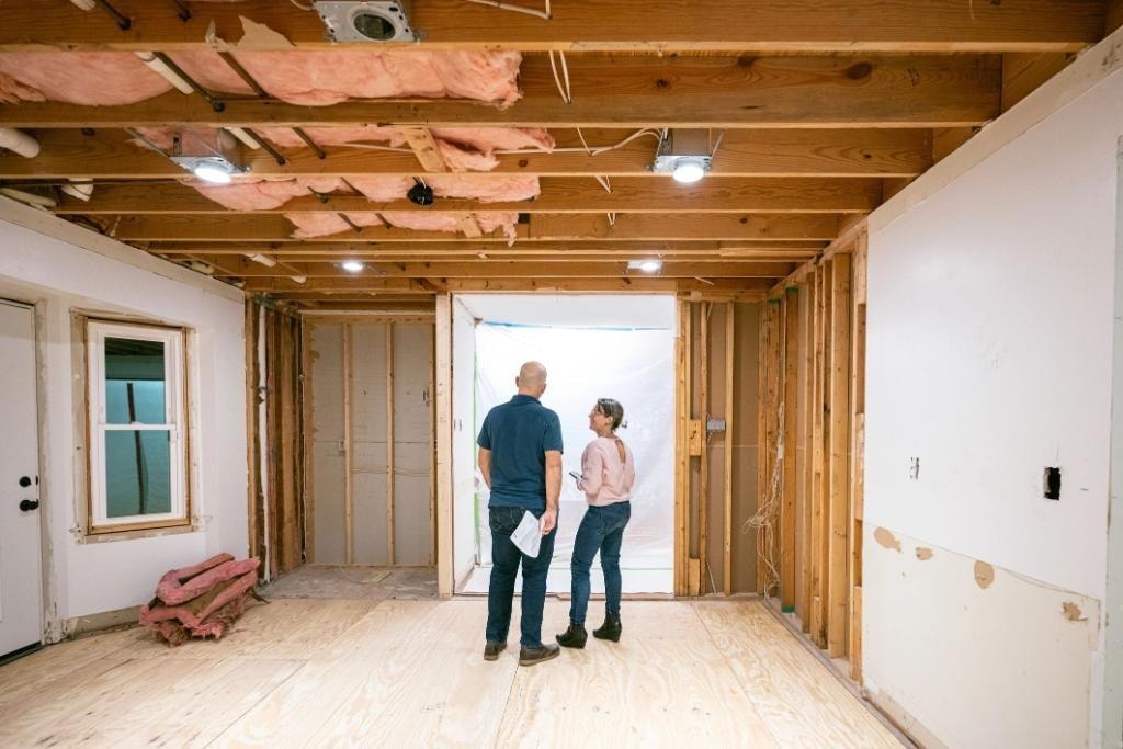 Two people inspecting a fix and flip renovation property